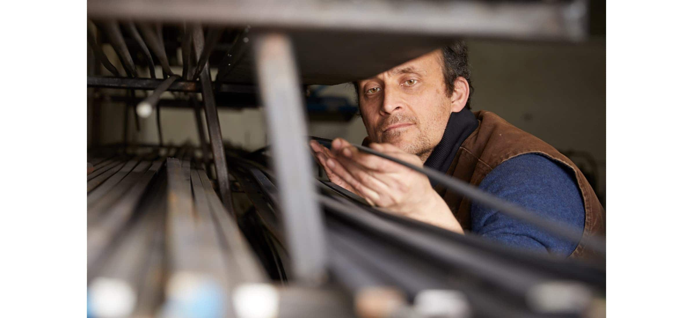 Business founder Richard Fishenden inspects some metal in their workshop.